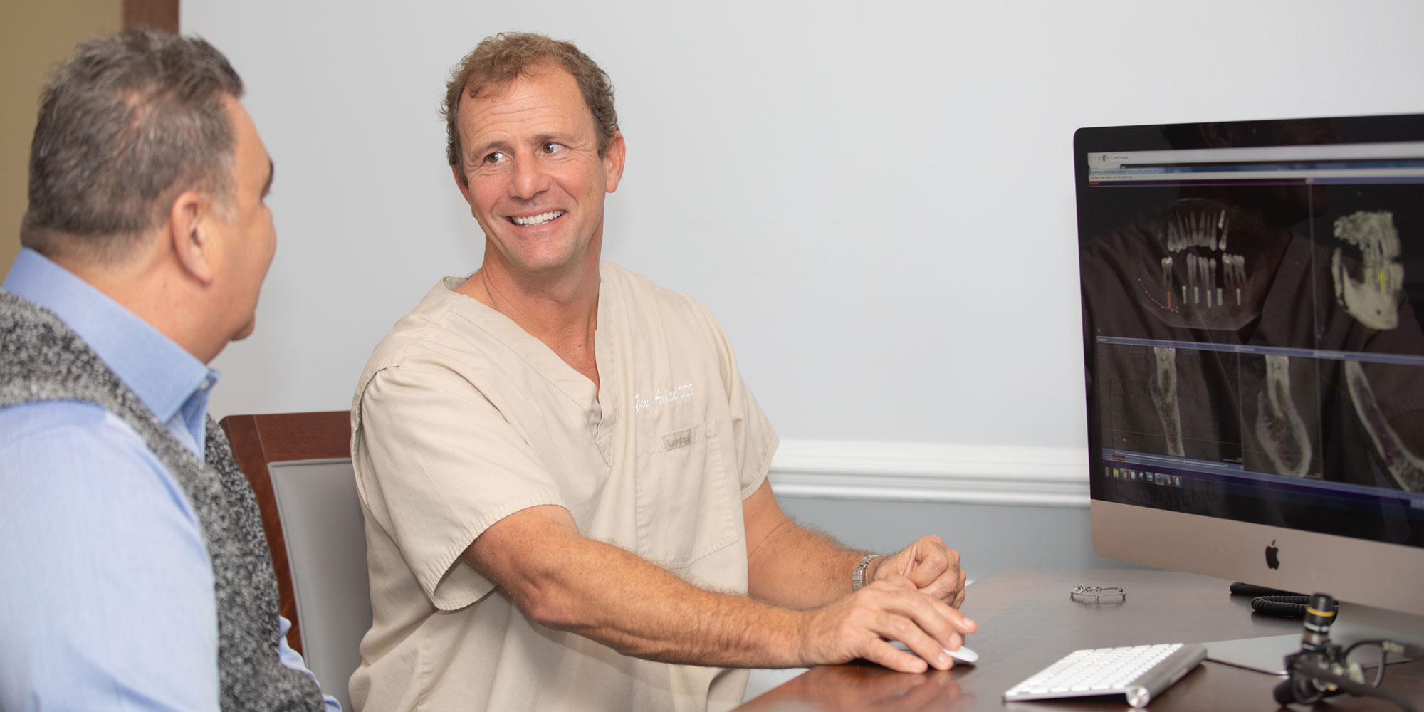 dr ashton discussing dental implants with patient Leesburg, VA